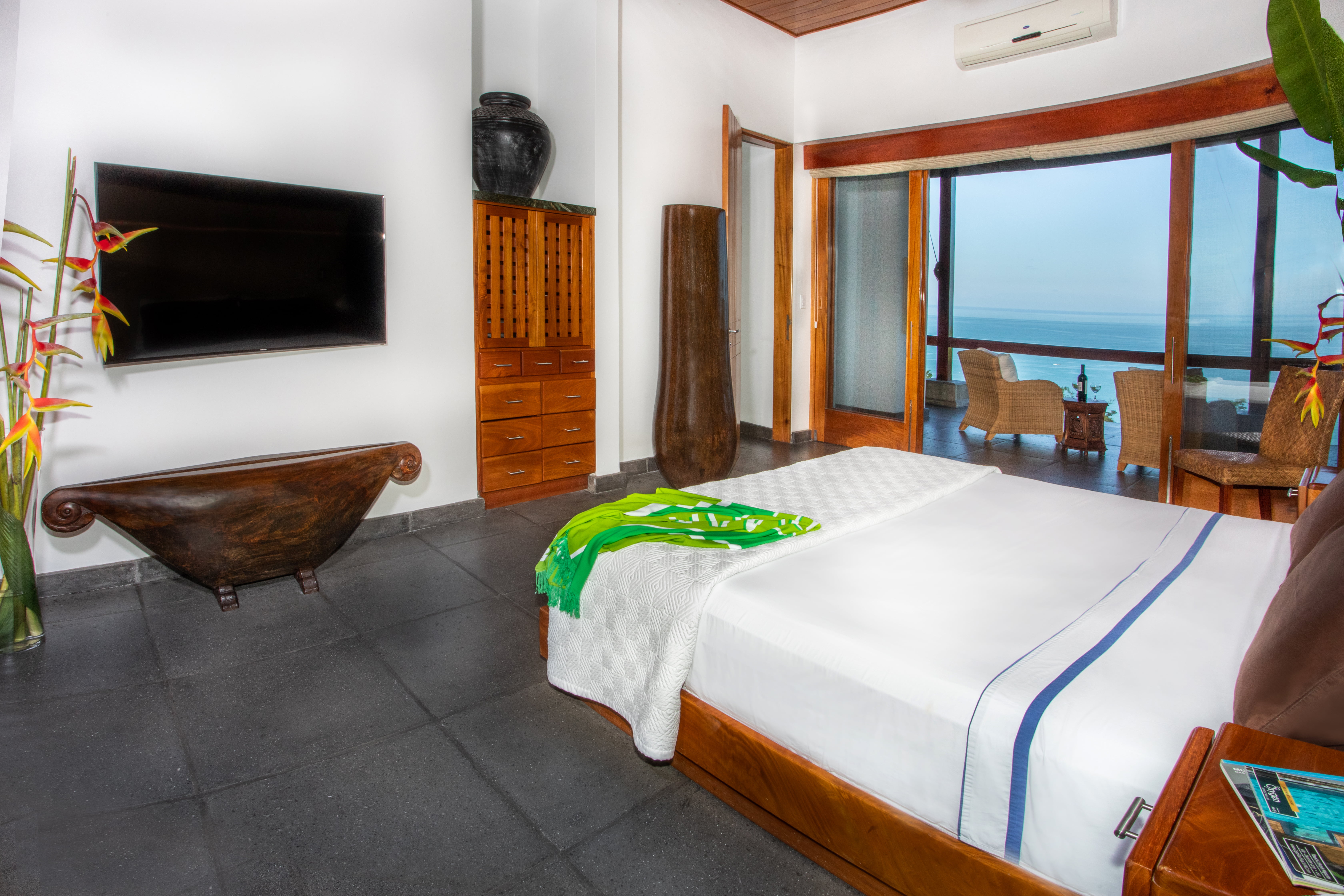 Primary bedroom and balcony with ocean views