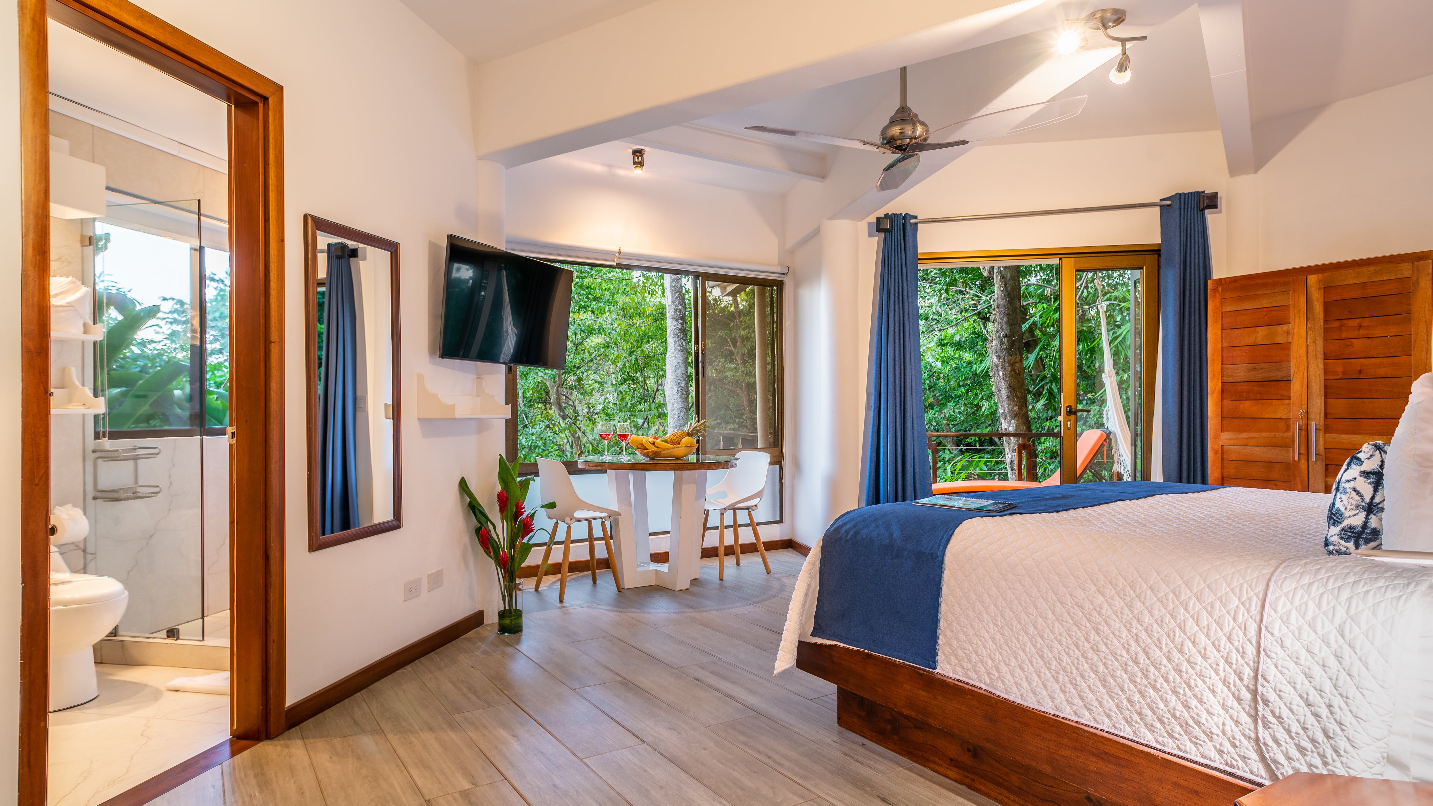 King bed, bathroom, TV, indoor dining, and terrace