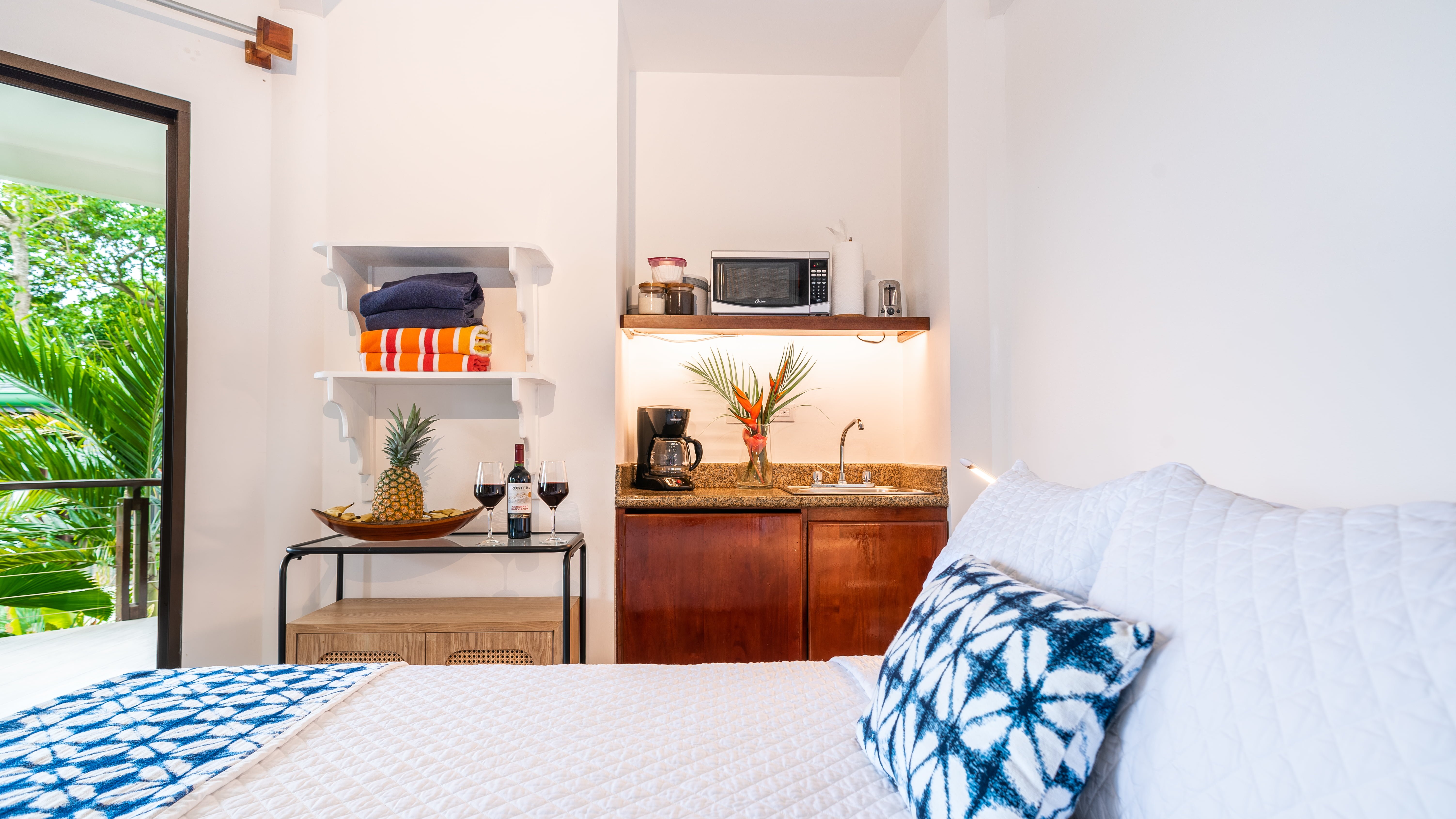 Wet bar with microwave, coffee maker, and small refrigerator