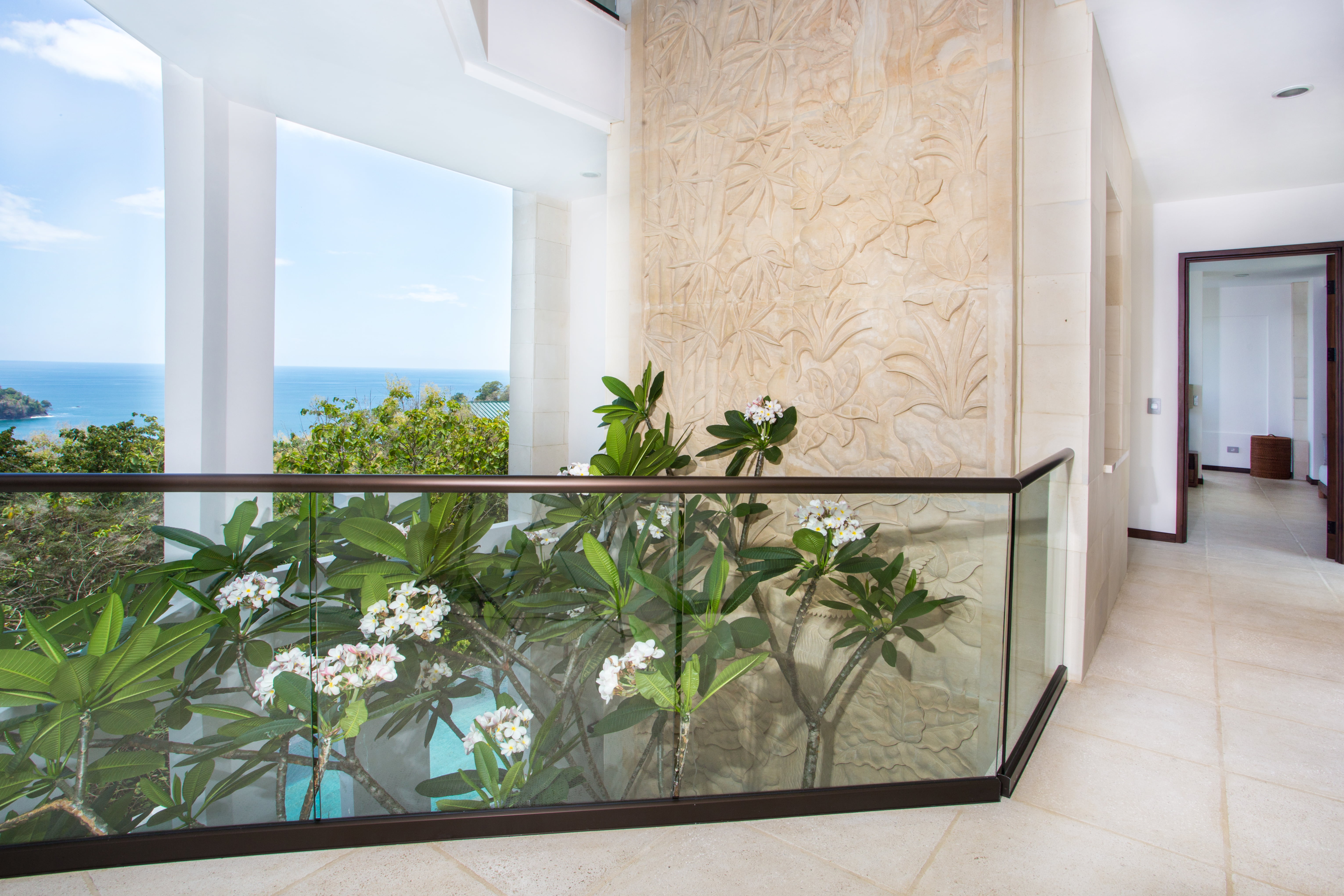 4th floor - The frangipani tree reaches through the 4th floor landing and the limestone carving extends upwards
