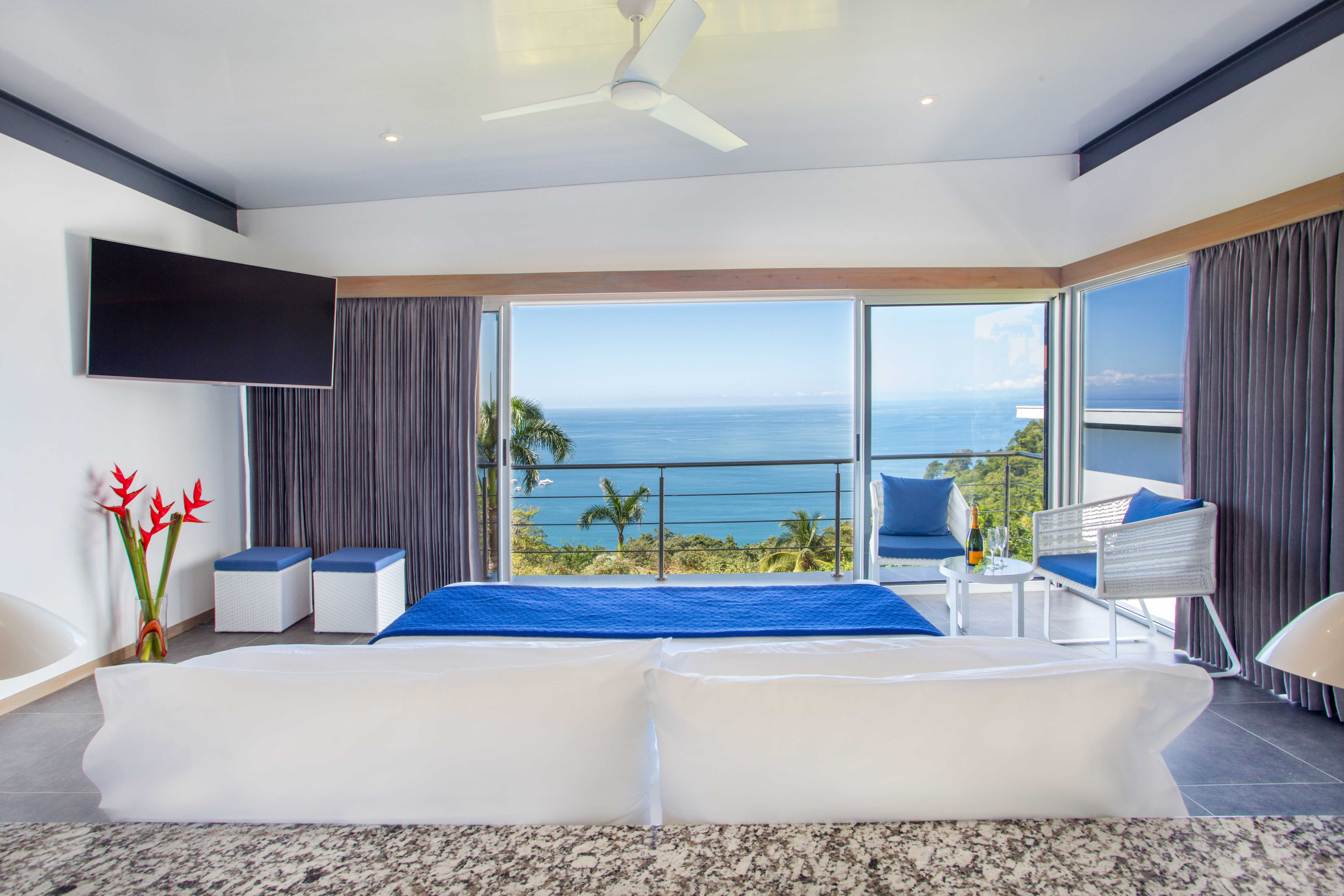 The view from the desk (not a bad place to work) plus a 55 inch TV, sitting area, and balcony